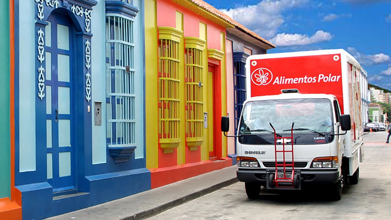 A colorful Empresa Polar truck driving down a street.