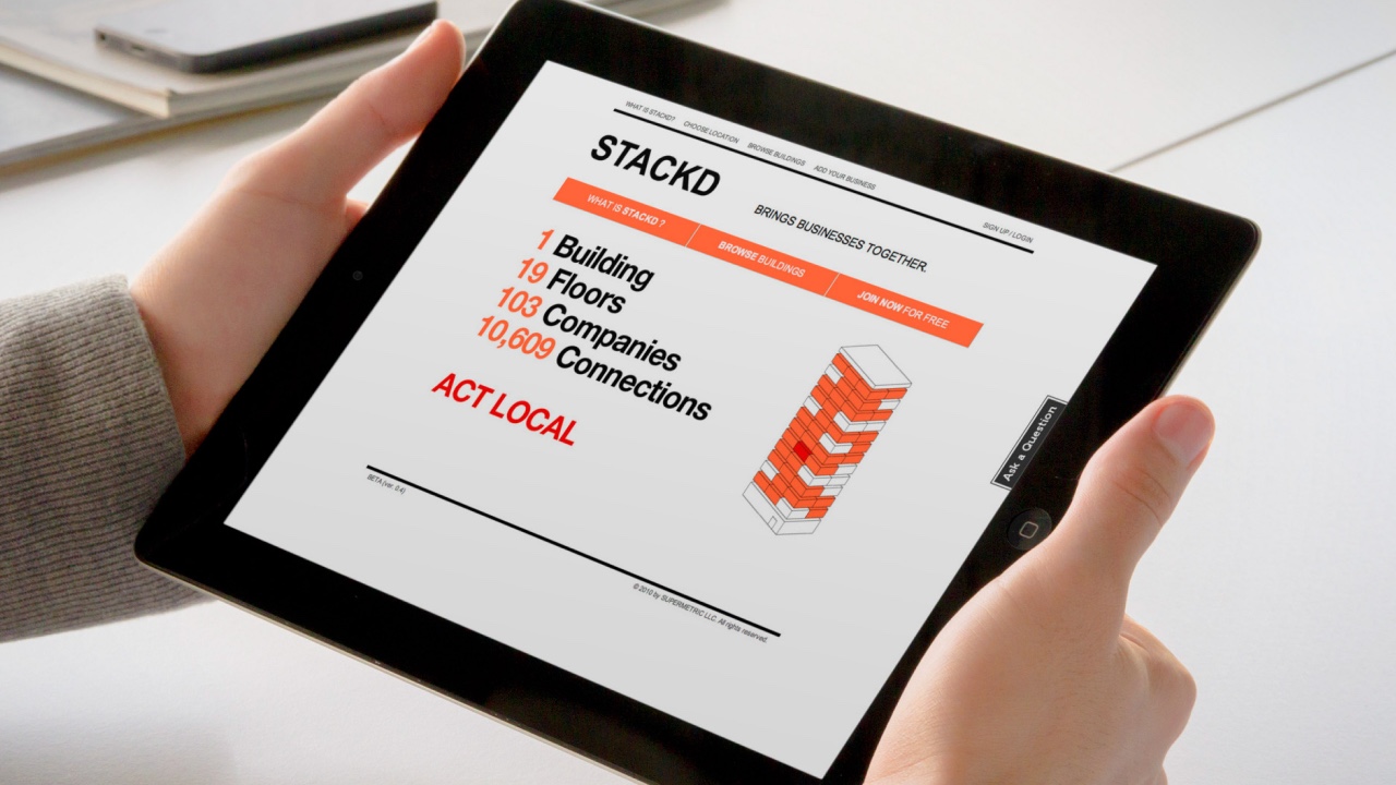 A person displaying a Stackd brochure on an iPad.
