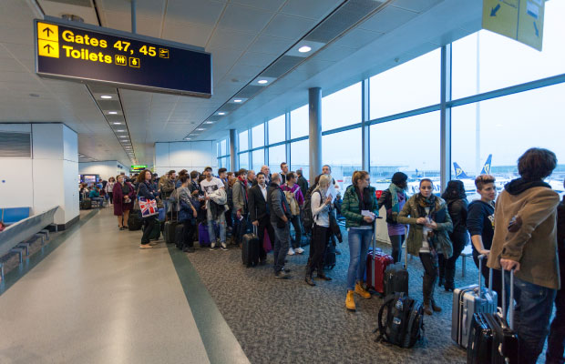 A line of people waiting to board a plane.