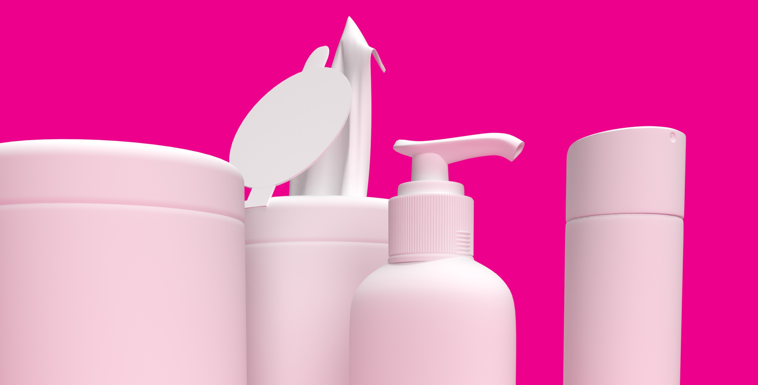 A group of pink cosmetics on a pink background.