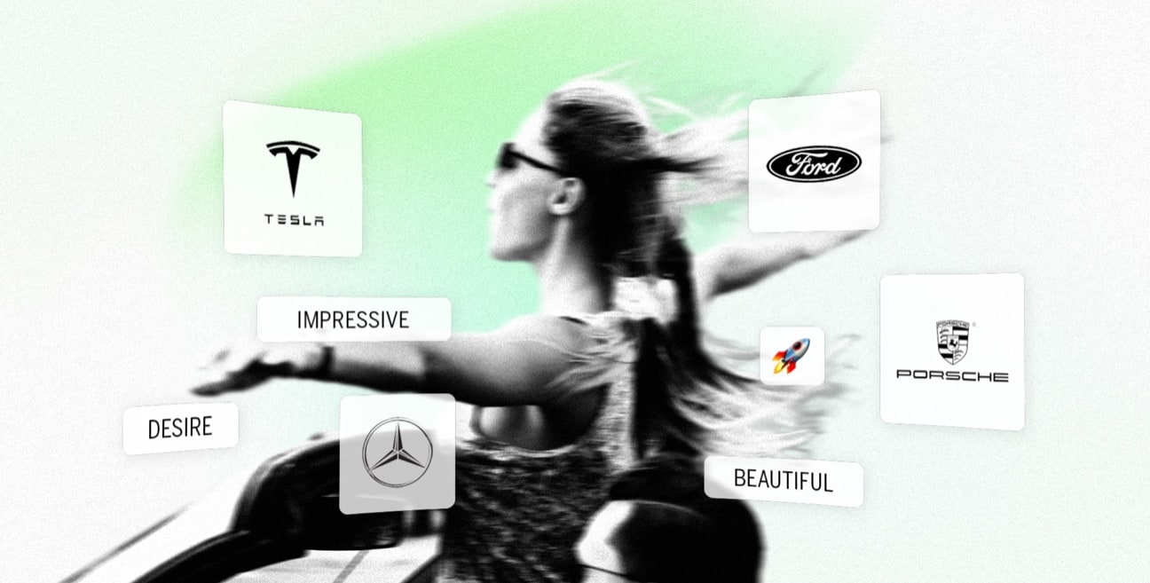a woman standing in a convertible car with outstretched arms with various automotive brand logos