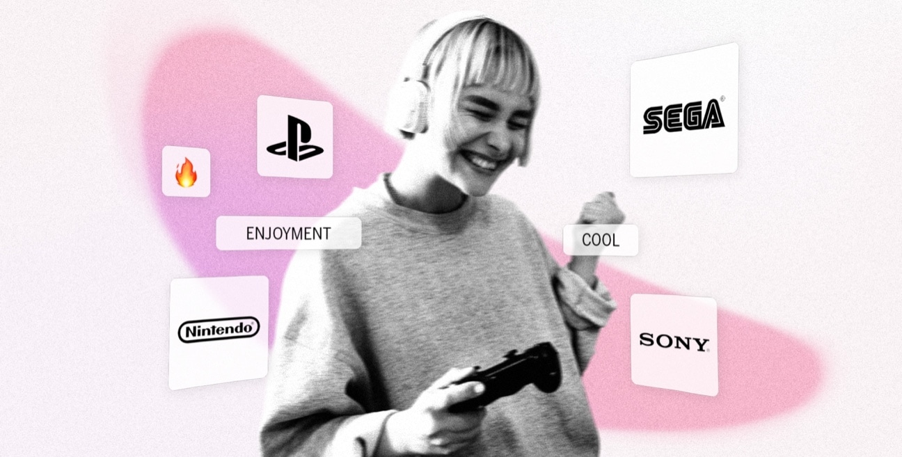 A woman holding a game controller in front of a pink background.