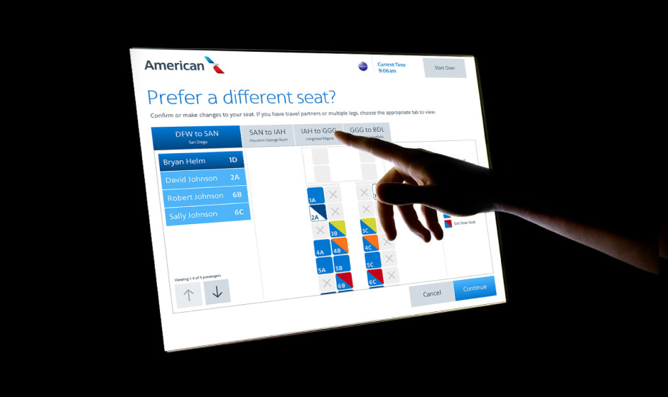 A person demonstrating user interface design concepts by pointing at a screen with an American Airlines logo.