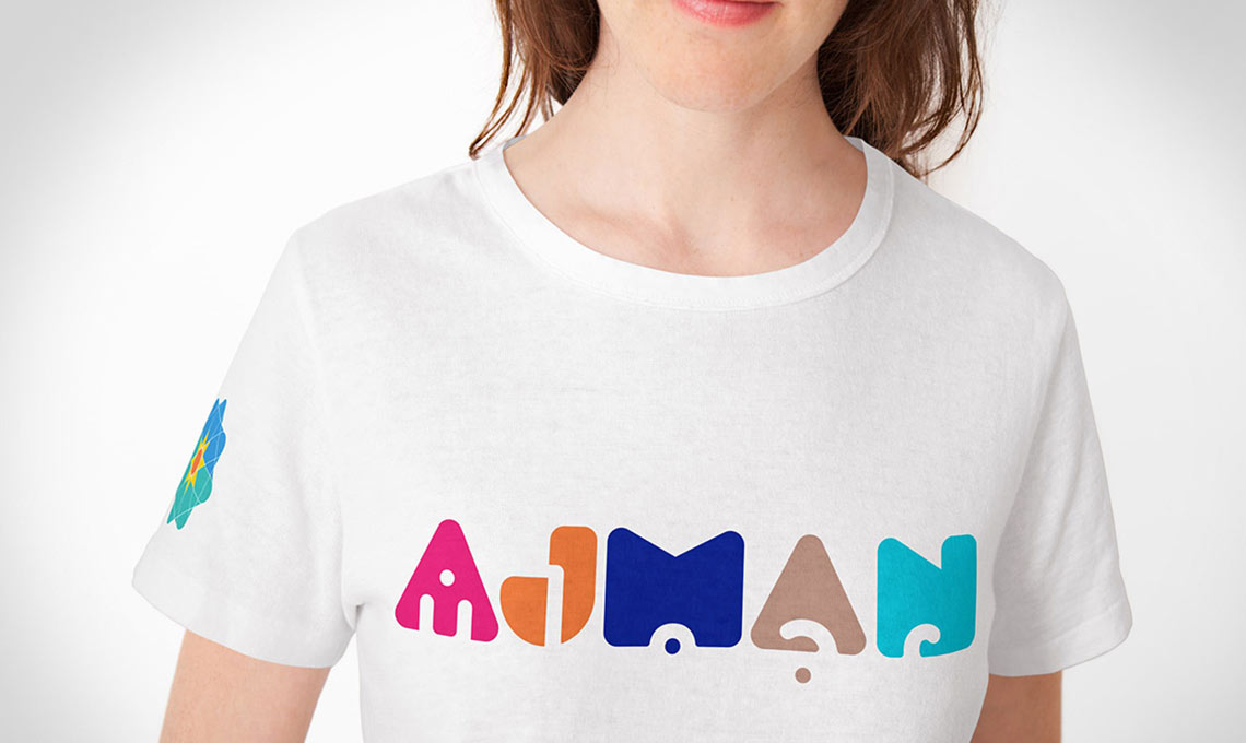 A woman wearing a white t - shirt with the word mamia on it.