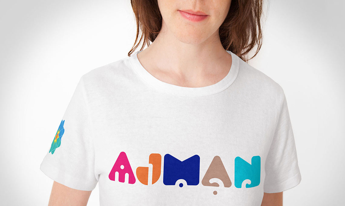 A woman wearing a white t - shirt with the word mama on it.