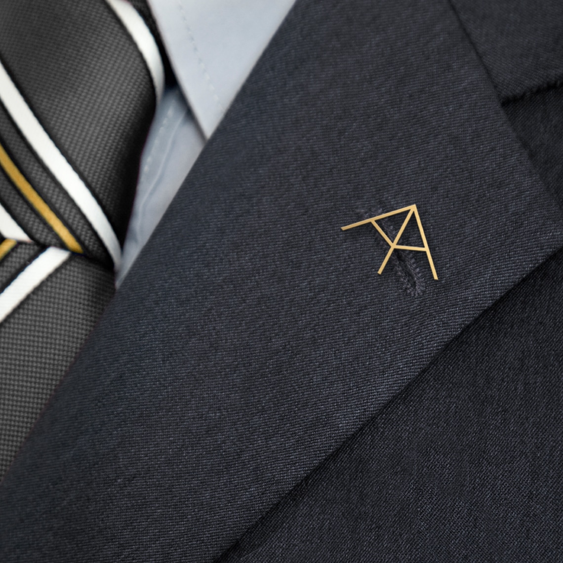 Atalaya symbol applied as a pin on a suit lapel
