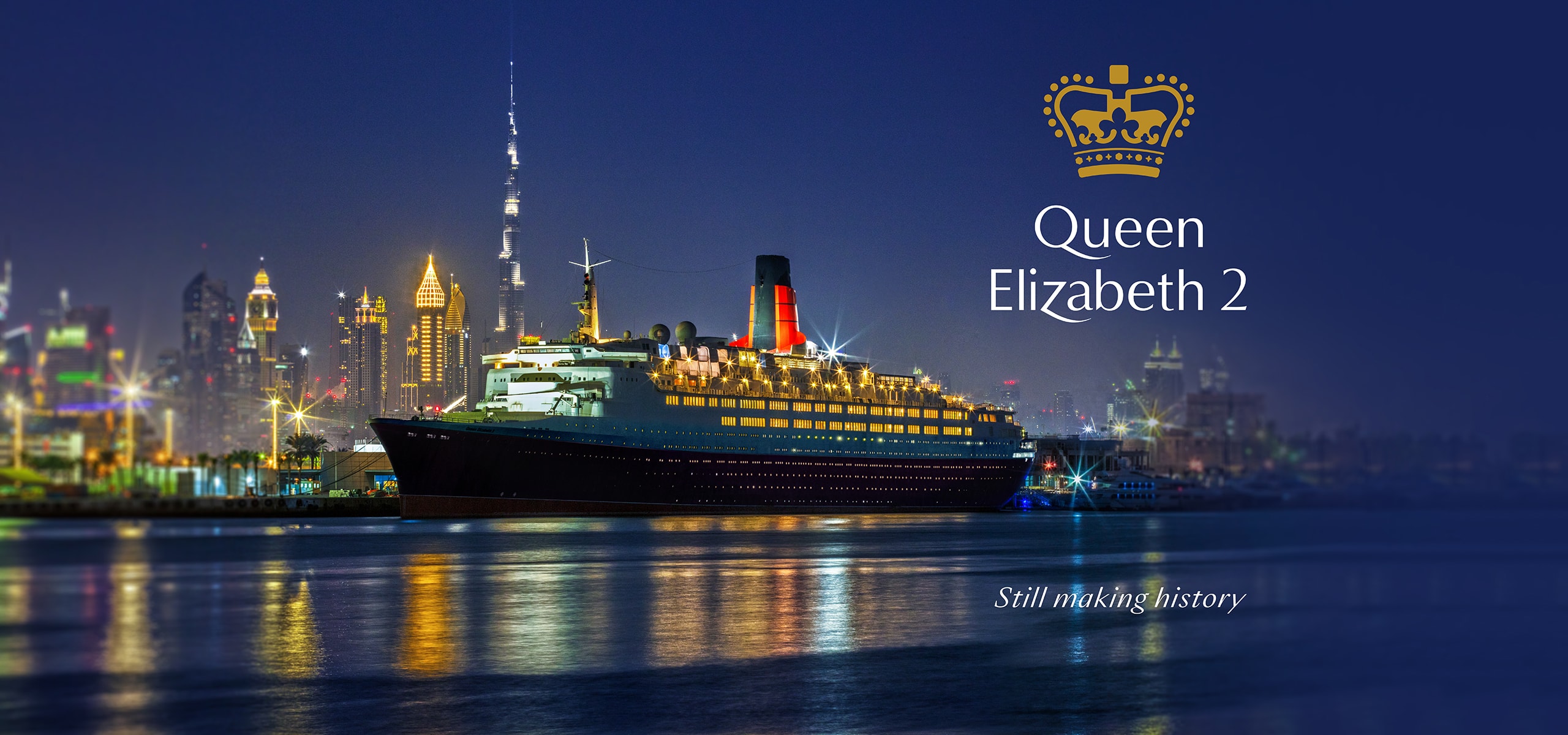the QE2 anchored in a harbor at nightfall, a Monumental Rebrand for a Maritime Legacy