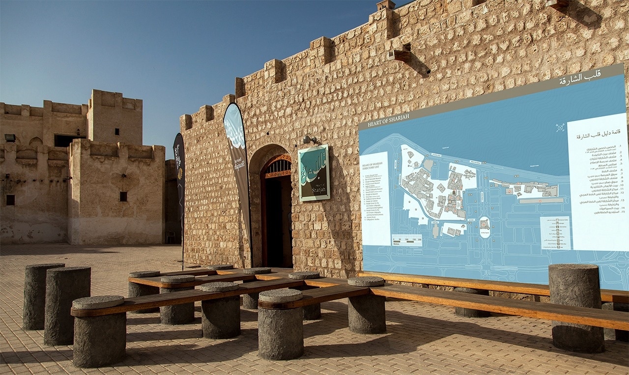 a stone wall with a map of the historical heart of the emirate of Sharjah on it