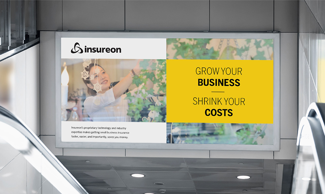 An escalator with a sign that says grow your business, save your costs, enhancing brand presence.