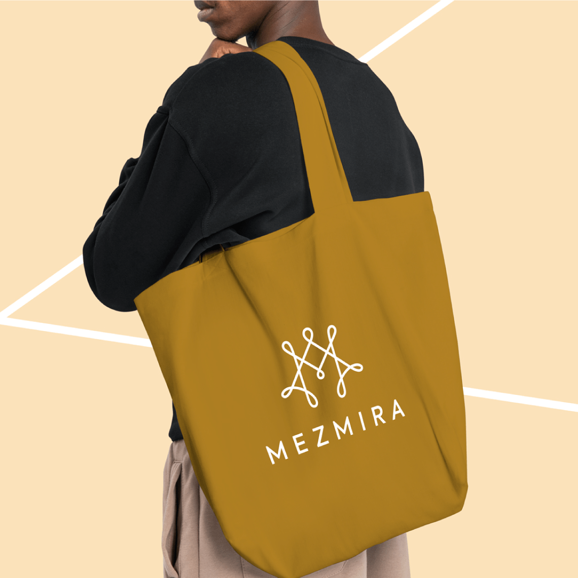 Mezmira logo applied on an elegant ochre-colored women's handbag