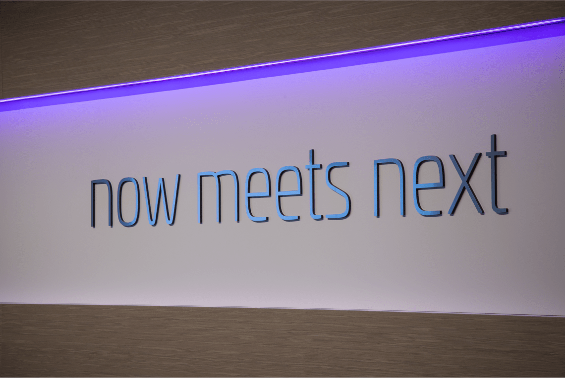 horizontal banner with tagline "now meets next"
