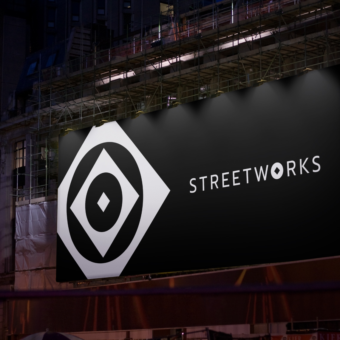 a black billboard over a construction site with the logo applied in white