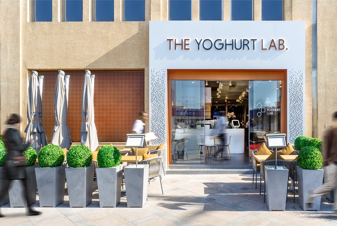 The Yoghurt Lab logo on the facade of a storefront