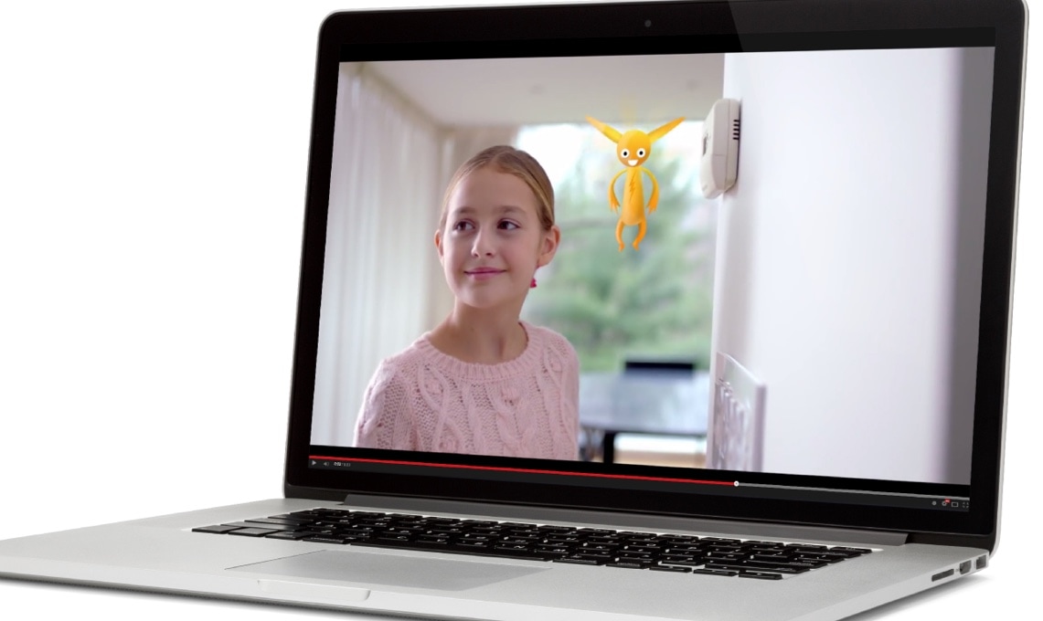 a laptop with a preview of a video showing a smiling girl and a yellow critter