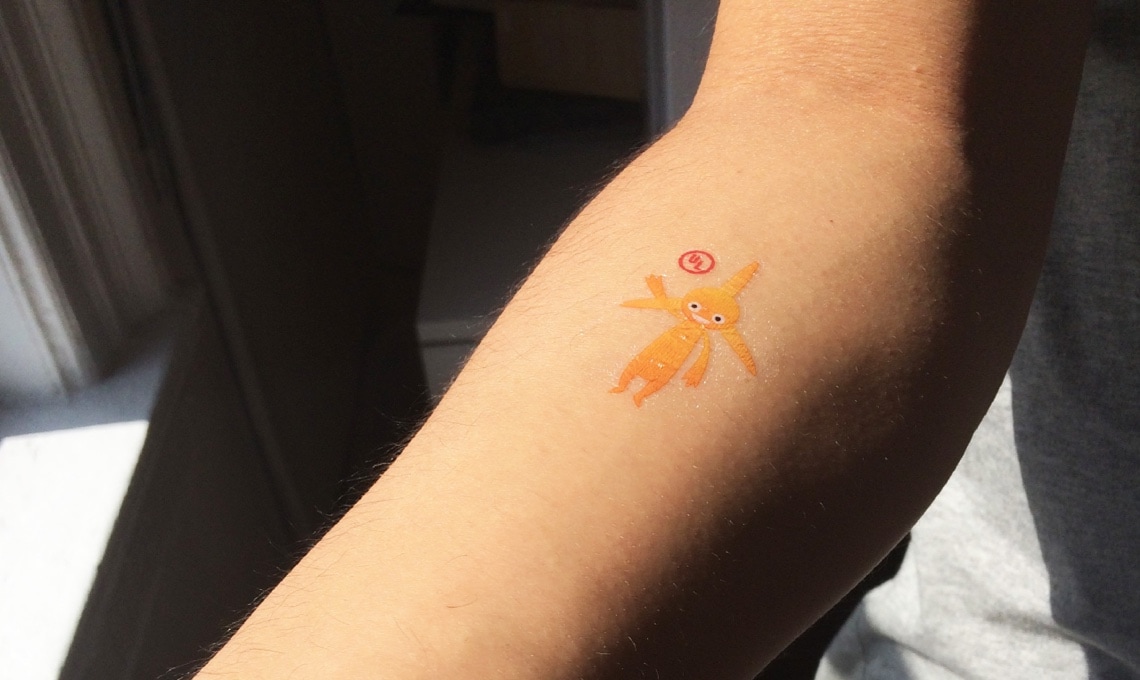 A person with a tattoo of a pokemon on their forearm.