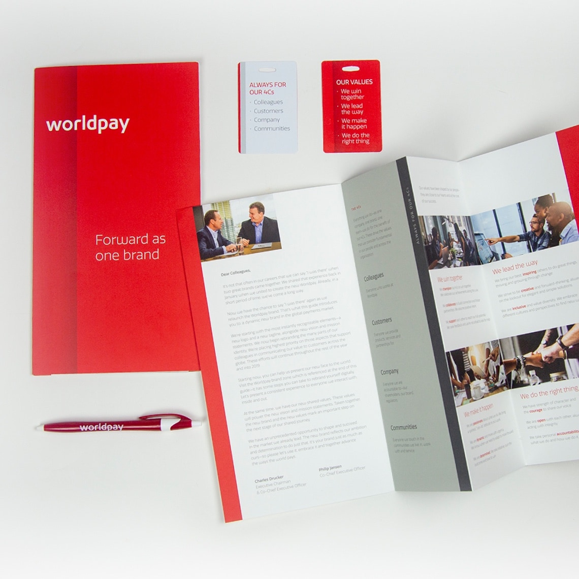 Examples of printed material including brand brochure, ID cards, and branded pen