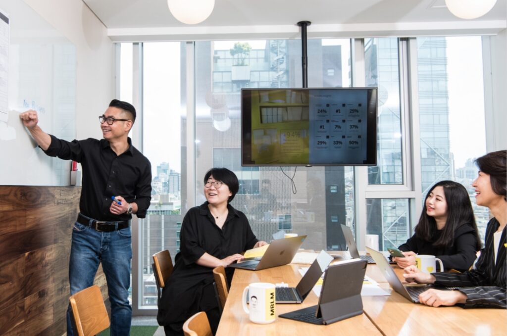 Group of Mblm employees at a meeting in Seoul office