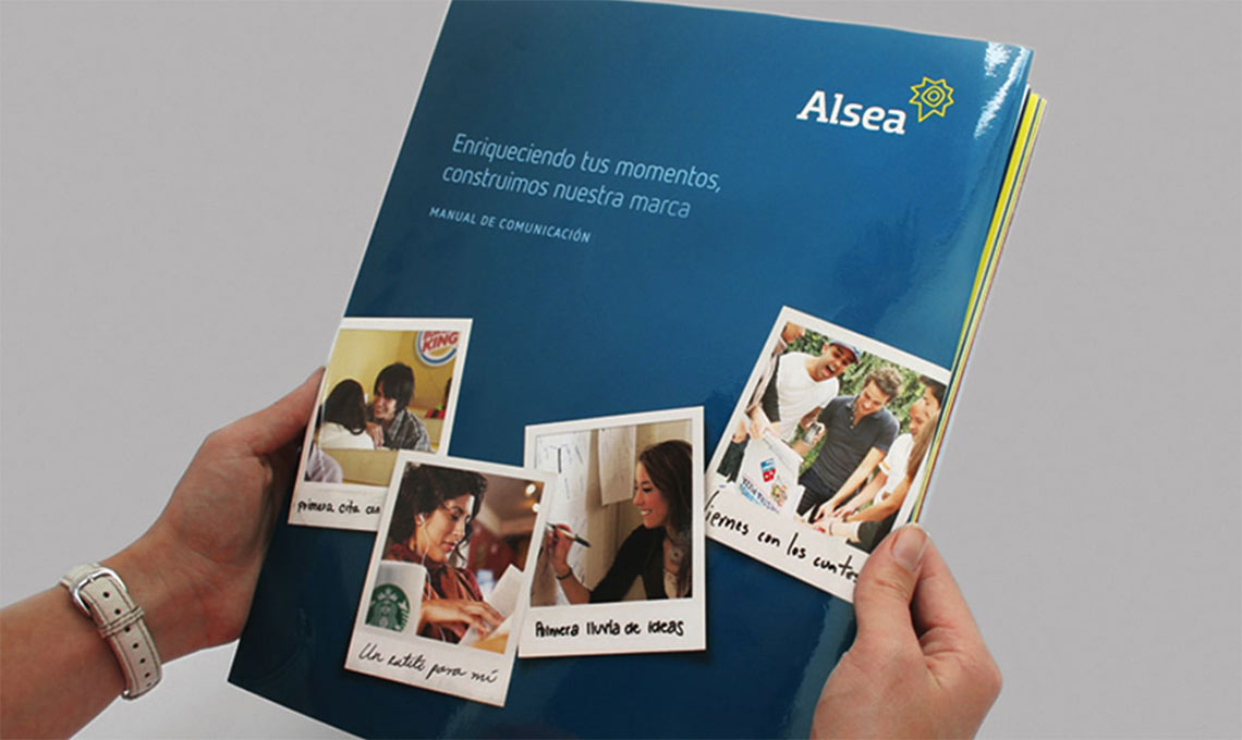 A person is holding a brochure featuring brand repositioning.