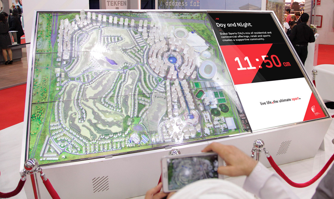 A man redefines the home-field advantage by taking a picture of a map on a display.