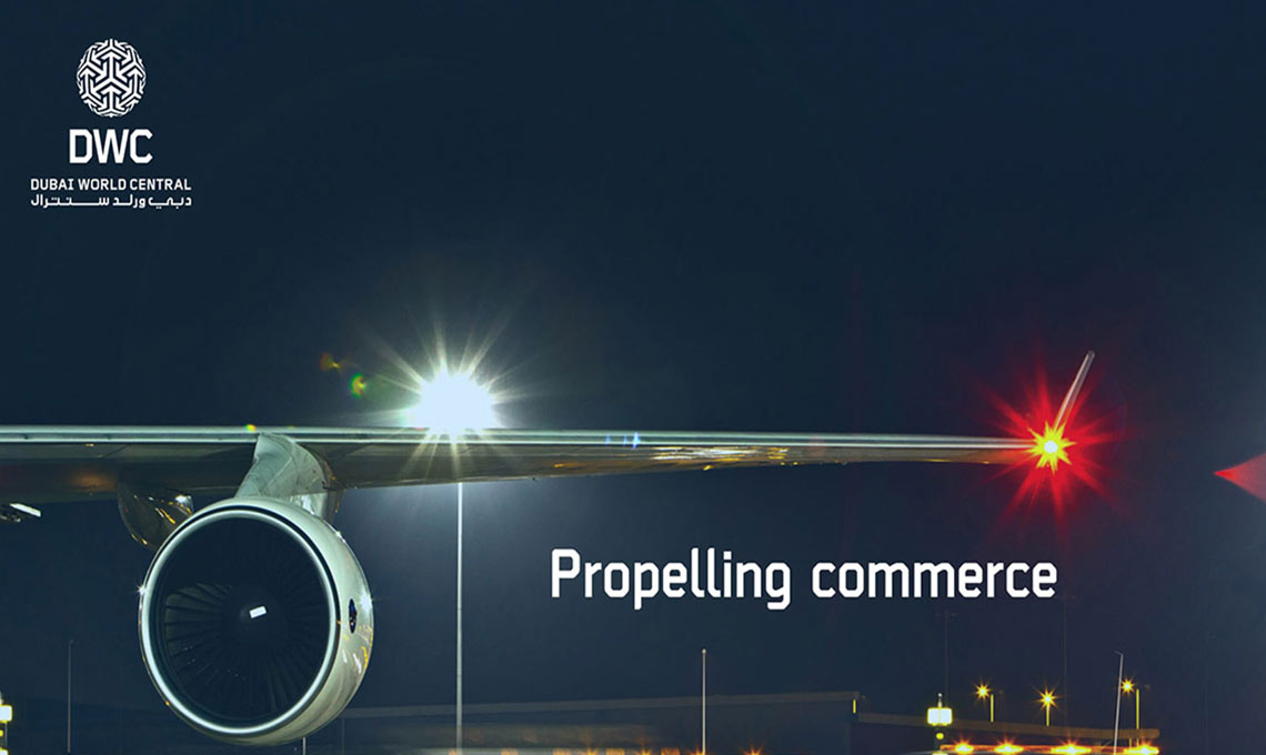 A plane parked at an airport with the words propelling commerce.
