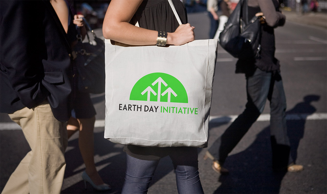 A woman carrying a tote bag that says birthday initiative, aligning a brand to its future.