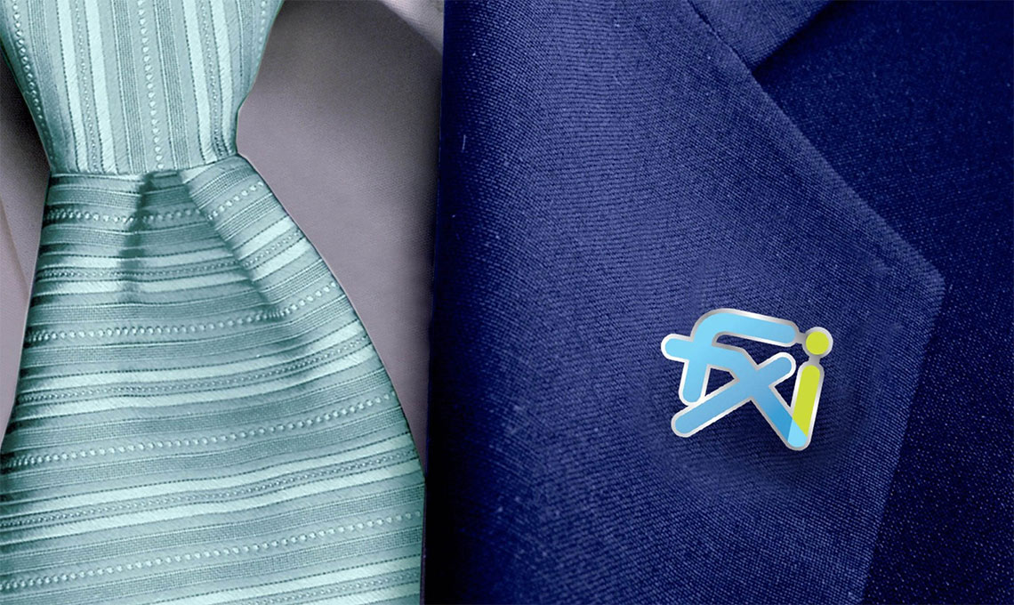 FXI logo applied as a pin on a suit lapel