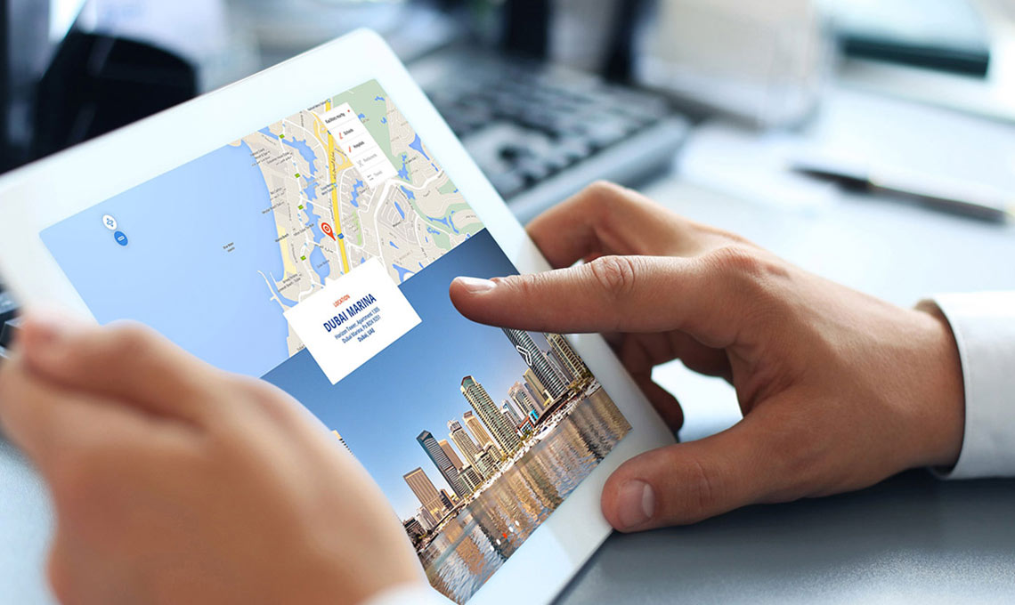 A person holding an ipad with a map on it for a corporate website.