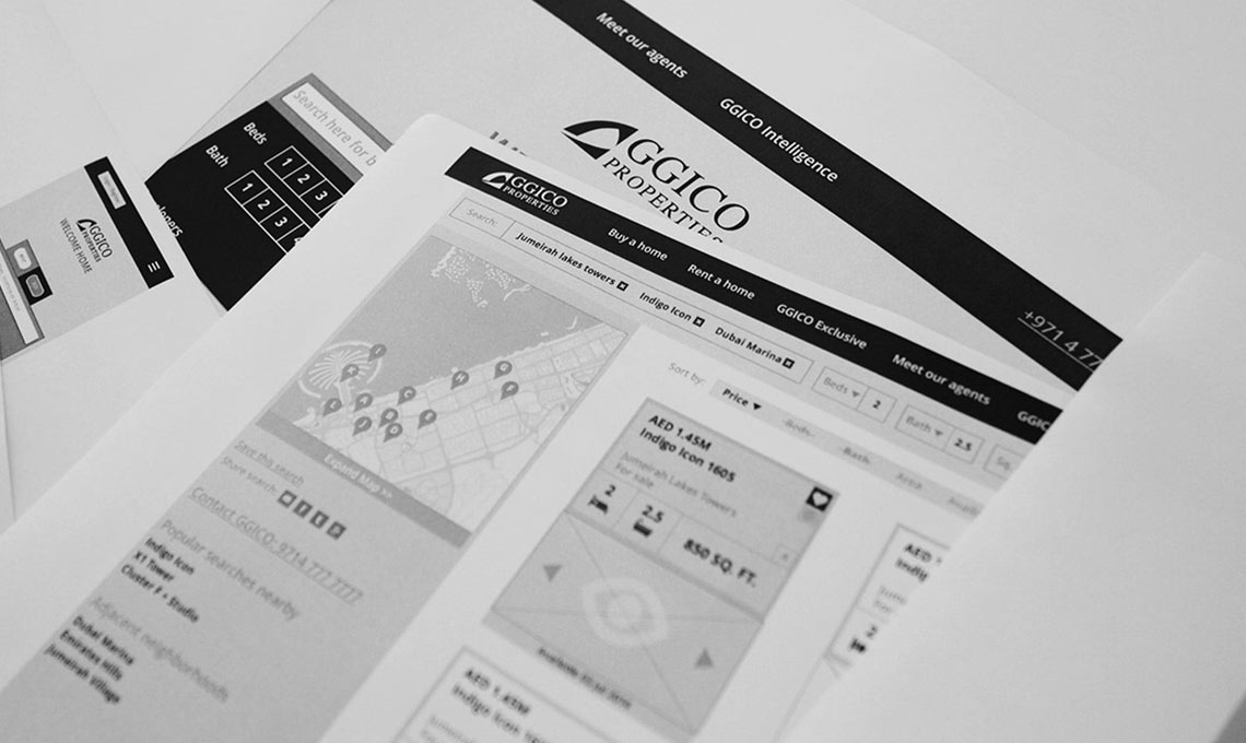 A black and white photo of a business card and a piece of paper for a corporate website.