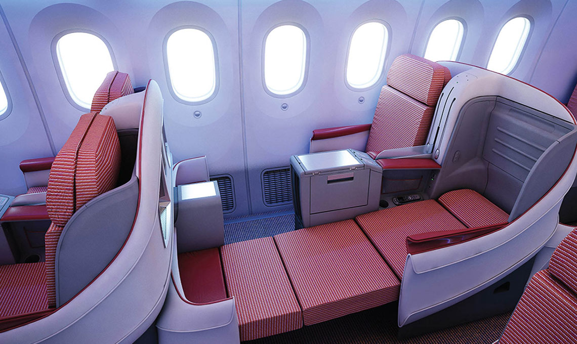 The interior of an airplane with red seats and windows.
