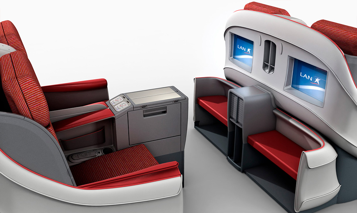 A red and white airplane seat with a monitor and television showcasing a sleek seat design.
