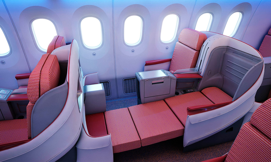 The interior of an airplane with red seats.