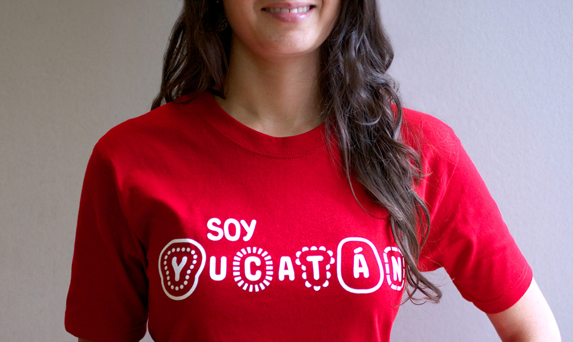 A young woman wearing a red t-shirt showcases destination branding.