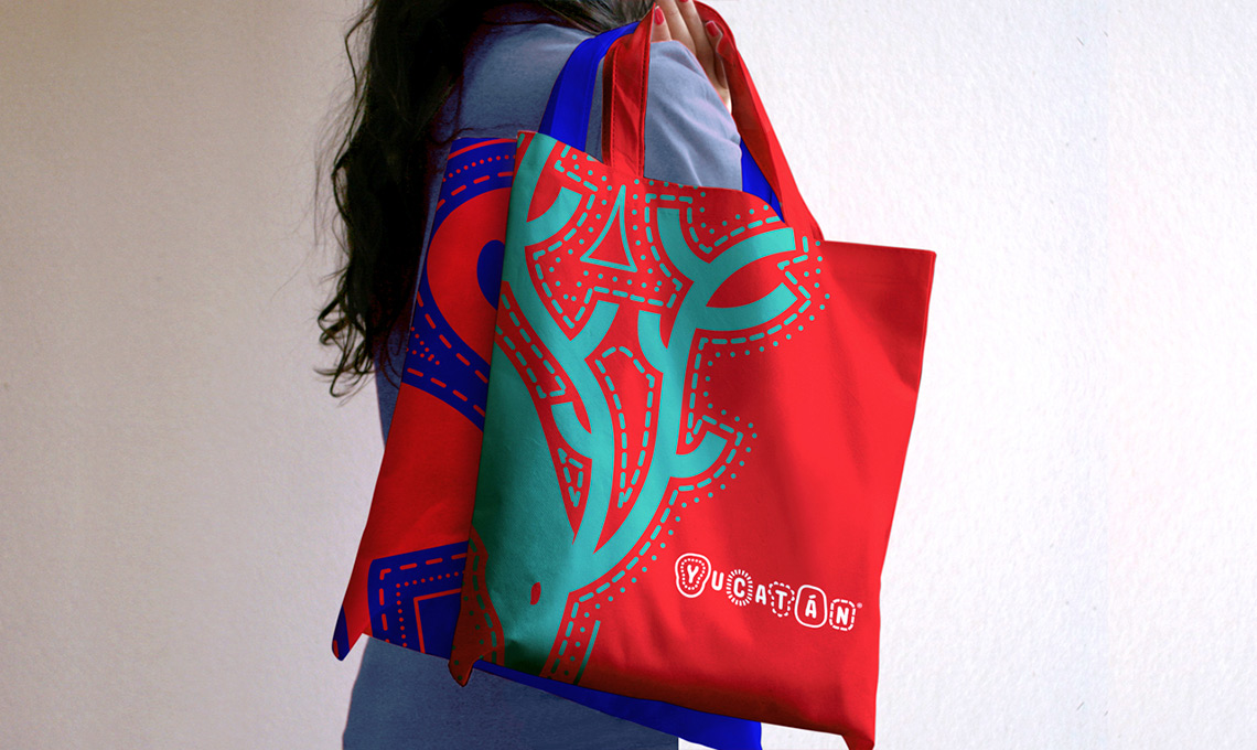 A woman holding a branded tote bag.