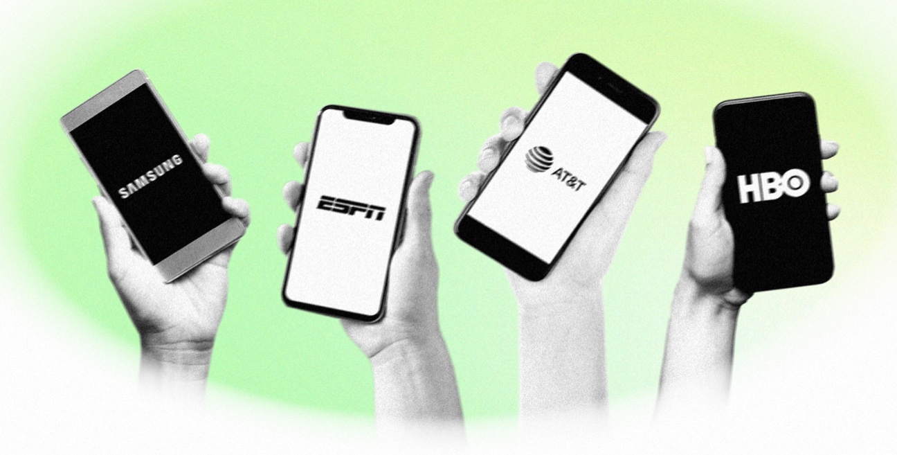 A group of people holding up phones with hbo, espn, fox, and cbs logos.