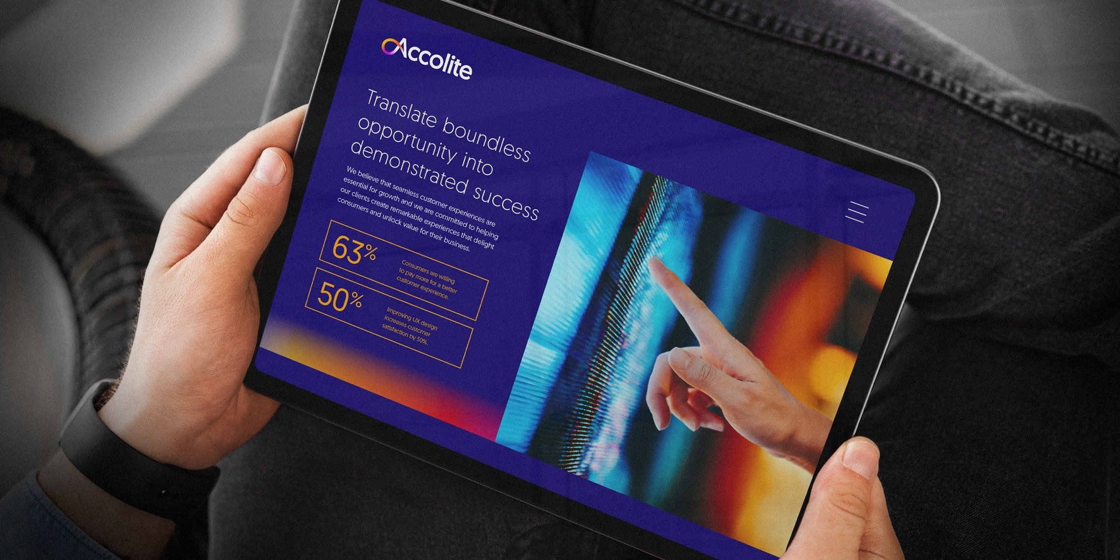 A man with a tablet in his hands with the website designed and developed for Accolite
