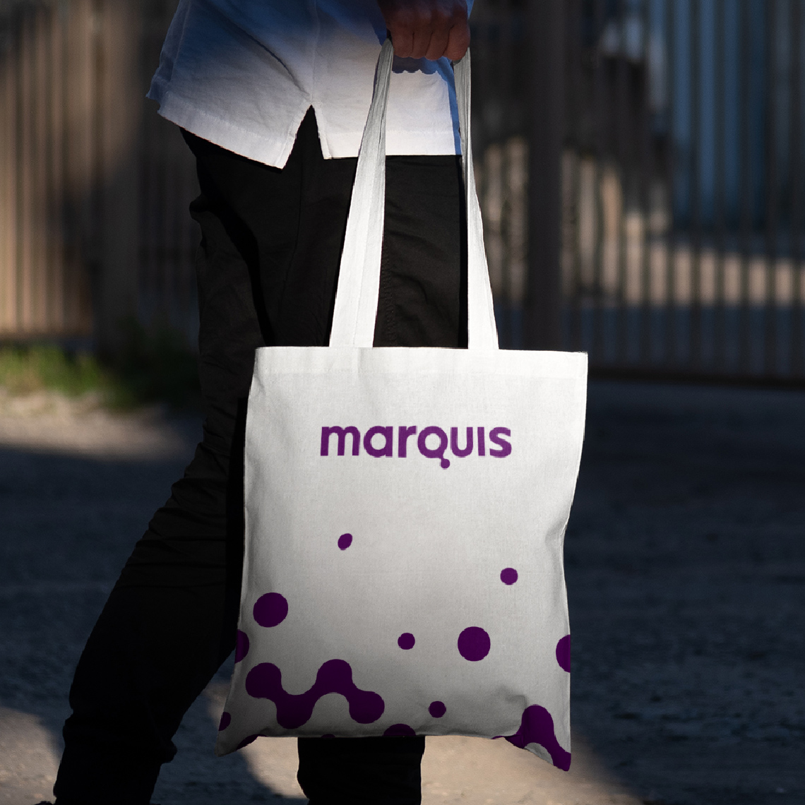 example of marketing material: a white Tote Bag the Marquis logo in purple