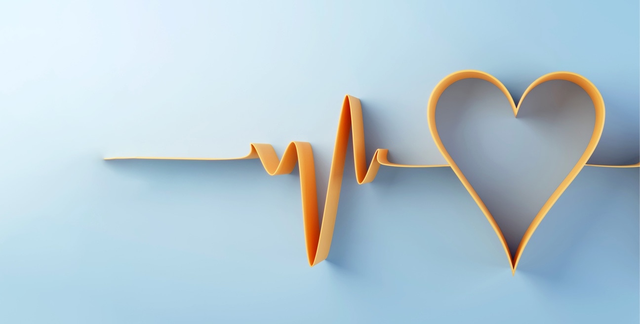 electrocardiogram waves that form a heart symbol made of orange paper on a blue background.