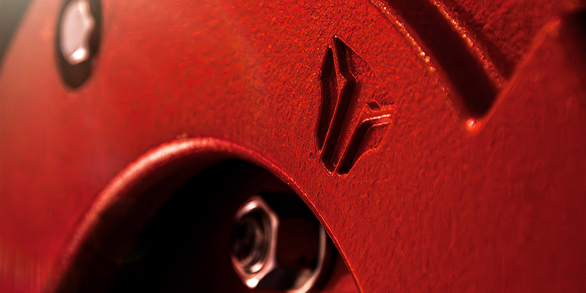 Close-up of a TYM tractor with Tiger-faced TYM logo engraving, designed by MBLM.