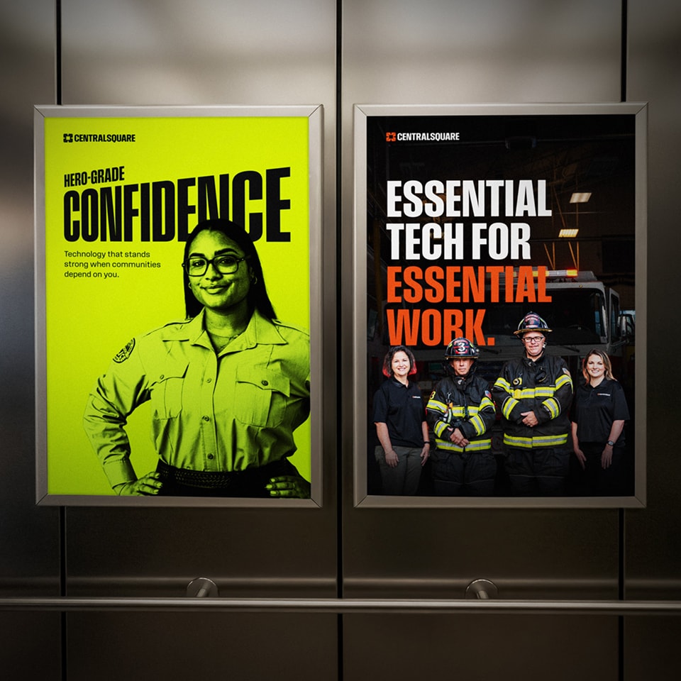 Two posters feature emergency responders; one shows a woman in uniform beside text about confidence, the other shows firefighters with text promoting essential technology for essential work.